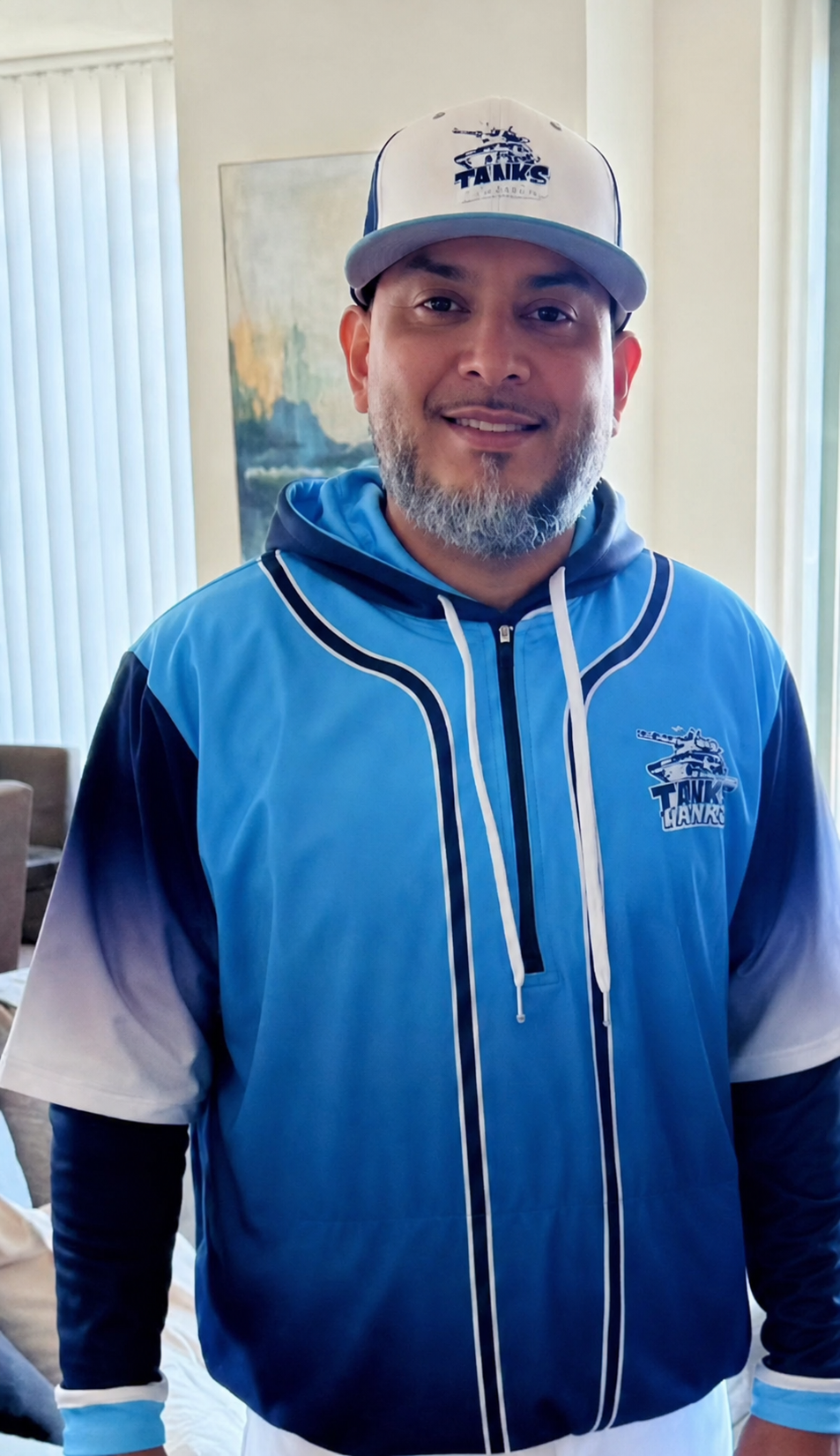 Coach Jorge wearing an NY Tanks cap and team hoodie